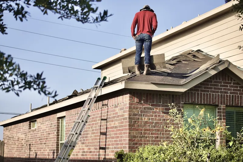 Professional roofer working on a residential roof in Evesham